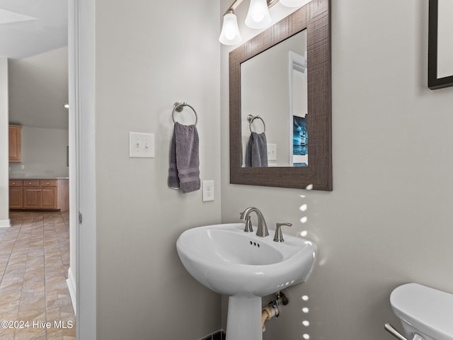 2610 Emerald Dr, Emerald Isle, NC 28594 - half bathroom featuring toilet, baseboards, and a sink
