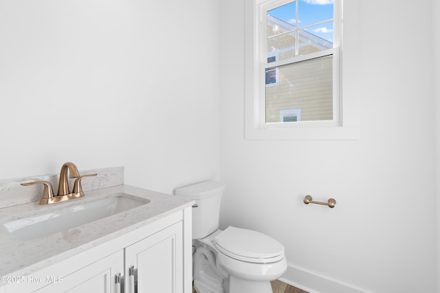 bathroom featuring toilet and vanity