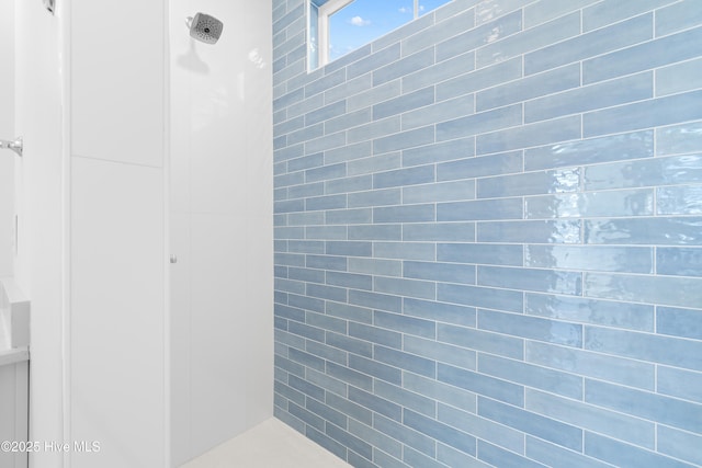 bathroom with tiled shower