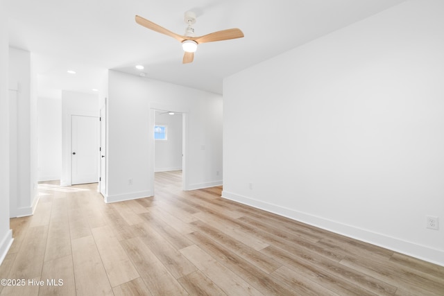 empty room featuring ceiling fan and light hardwood / wood-style flooring