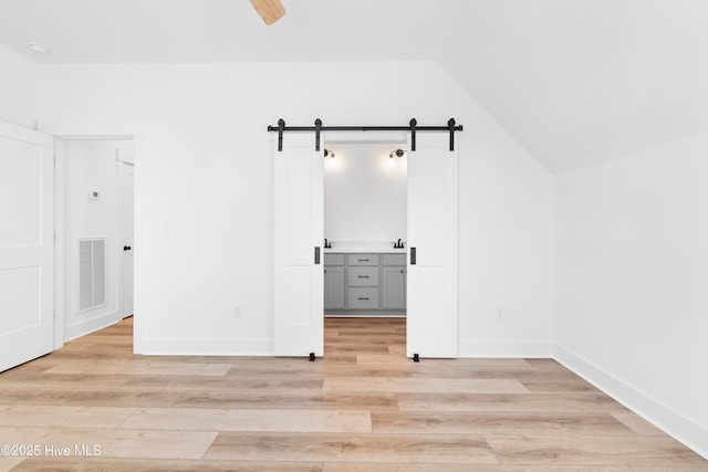 bonus room with lofted ceiling, light wood-type flooring, and ceiling fan