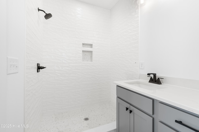 bathroom featuring vanity and tiled shower