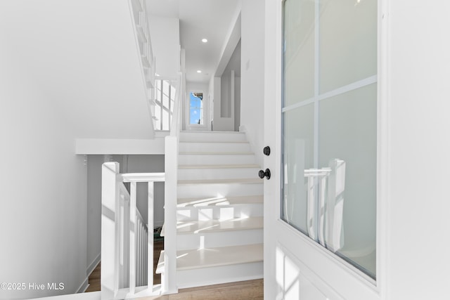 stairway featuring hardwood / wood-style floors