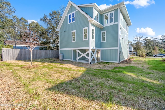 rear view of house featuring a yard