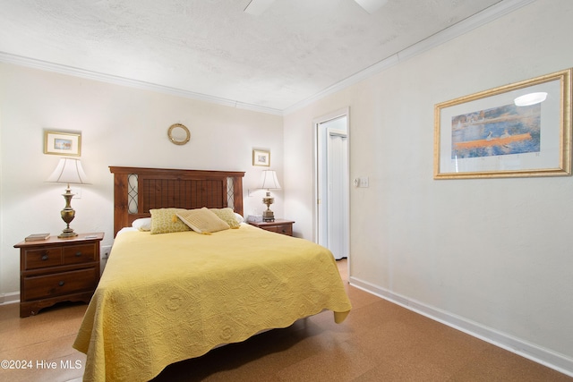 bedroom featuring a textured ceiling and ornamental molding