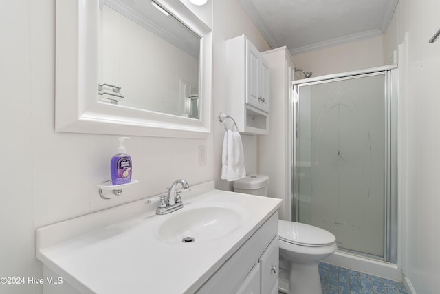 bathroom with vanity, toilet, a shower with door, and ornamental molding