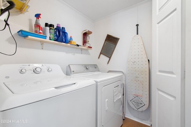 clothes washing area with crown molding and washer and clothes dryer