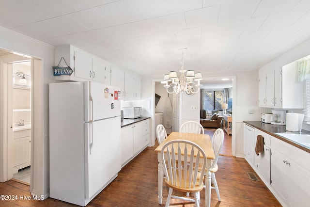 kitchen featuring white cabinets, white appliances, dark wood-type flooring, and tasteful backsplash