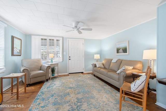 living room with ceiling fan and dark hardwood / wood-style flooring