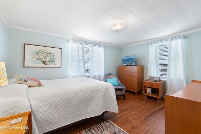 bedroom featuring dark hardwood / wood-style floors and ornamental molding