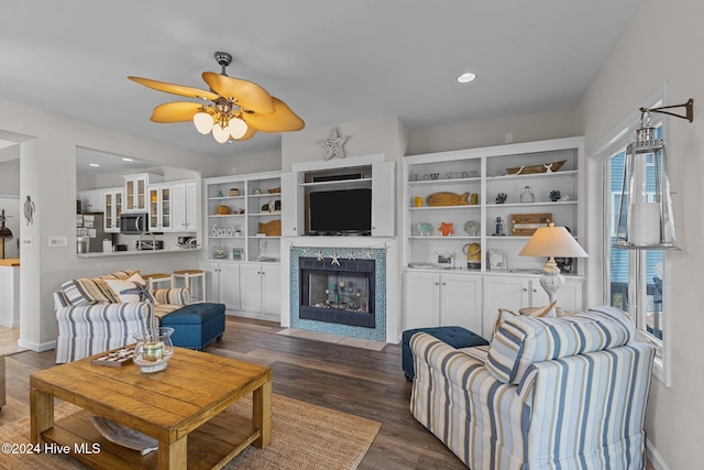 living room with ceiling fan and dark hardwood / wood-style flooring