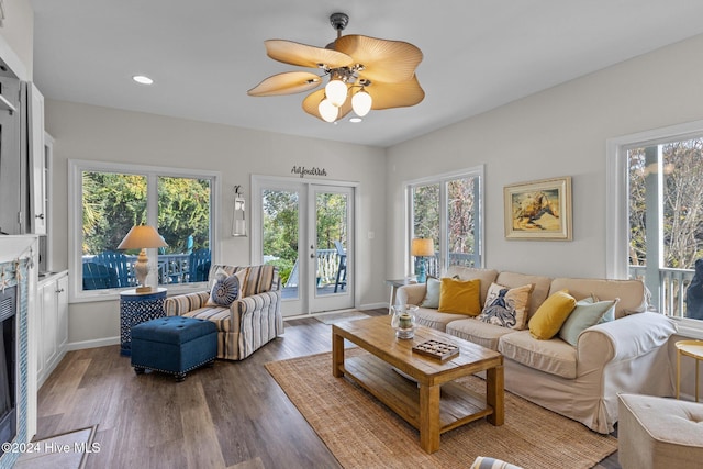 living room featuring hardwood / wood-style flooring, french doors, a healthy amount of sunlight, and ceiling fan