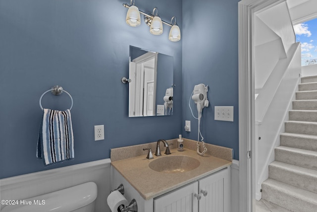 bathroom featuring tile patterned flooring, vanity, and toilet