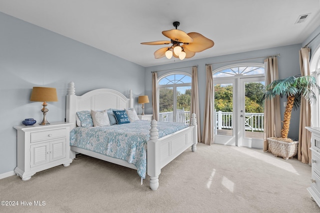 bedroom featuring access to exterior, light colored carpet, and ceiling fan