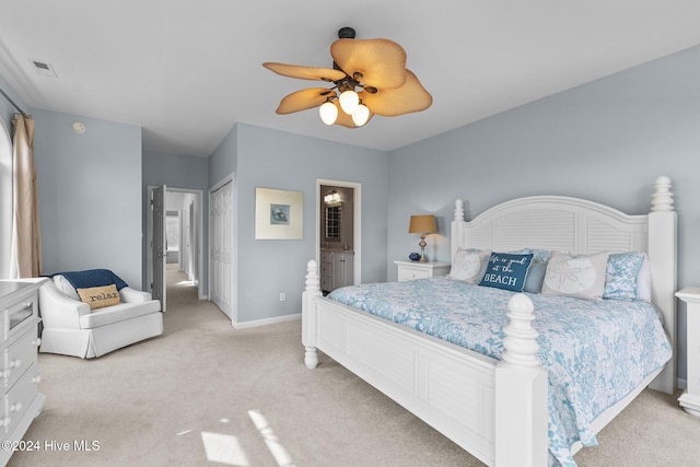 bedroom with connected bathroom, a closet, light carpet, and ceiling fan