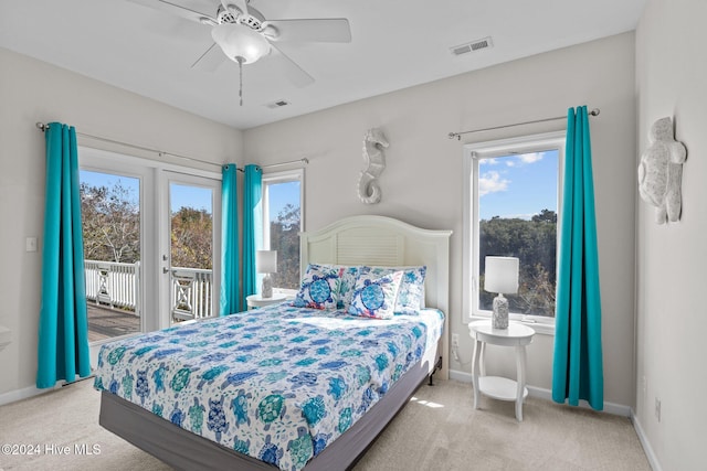 bedroom featuring carpet flooring, access to exterior, multiple windows, and ceiling fan