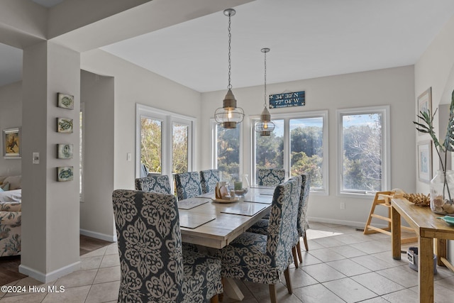 dining room featuring an inviting chandelier and light tile patterned flooring