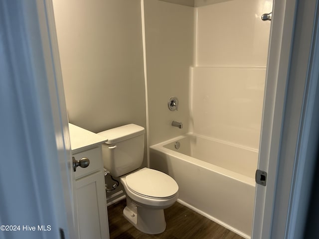 full bathroom featuring toilet, tub / shower combination, hardwood / wood-style flooring, and vanity