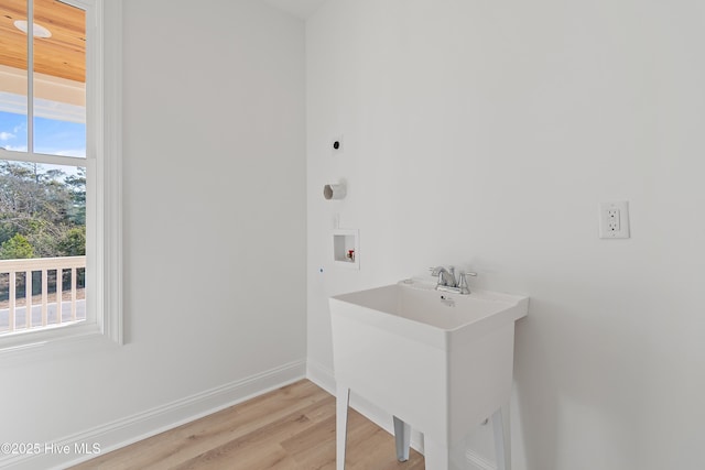 laundry area with sink, washer hookup, a healthy amount of sunlight, and hookup for an electric dryer