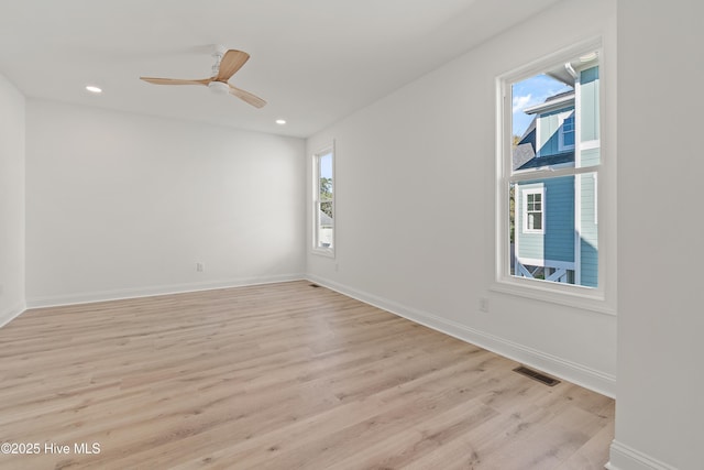 empty room featuring ceiling fan and light hardwood / wood-style flooring