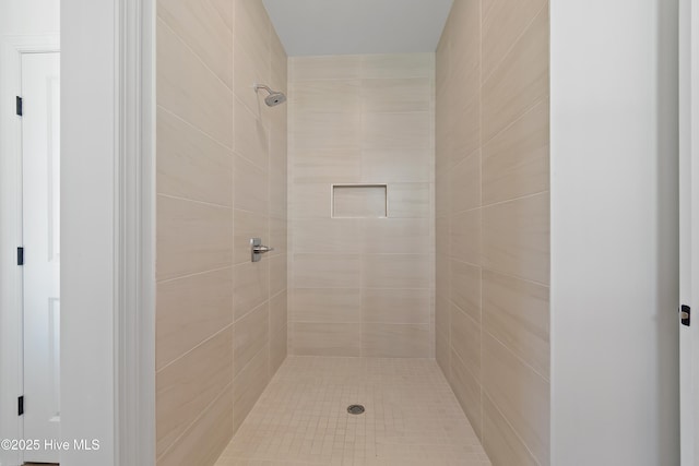 bathroom with tiled shower