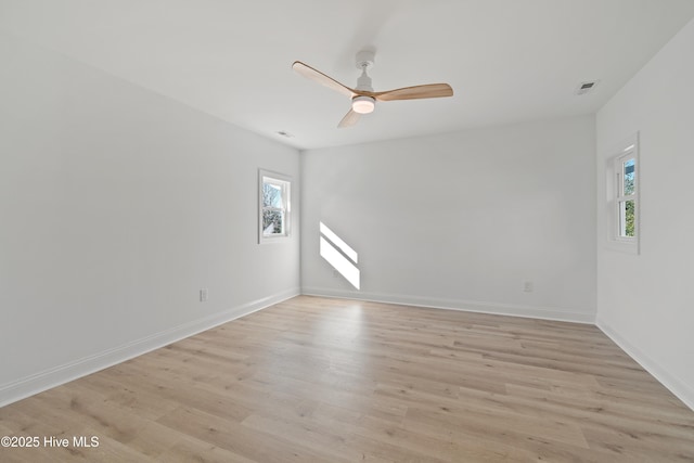 unfurnished room featuring light wood-type flooring, ceiling fan, and plenty of natural light