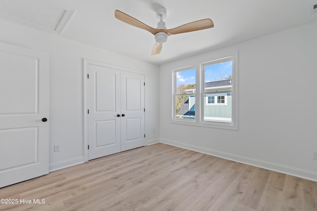 unfurnished bedroom with a closet, ceiling fan, and light wood-type flooring