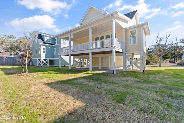 back of house featuring a lawn and ceiling fan