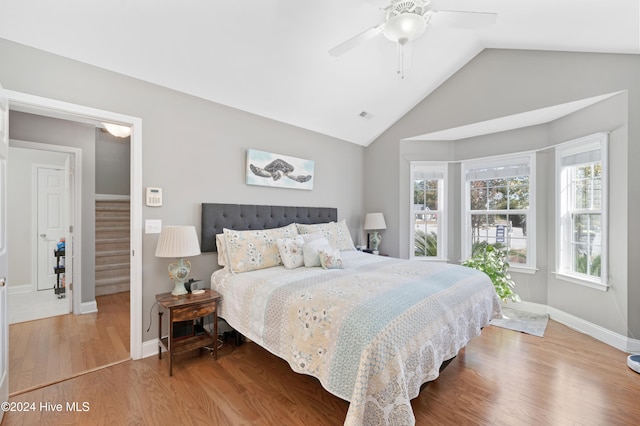bedroom featuring ceiling fan, vaulted ceiling, and hardwood / wood-style floors