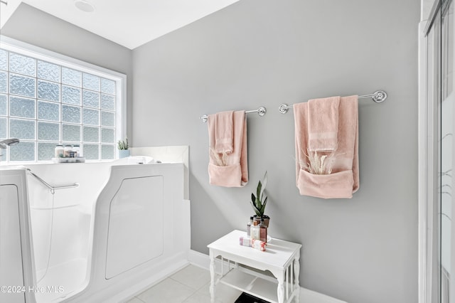 bathroom with separate shower and tub and tile patterned flooring