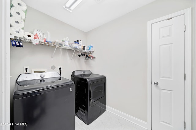 washroom with independent washer and dryer