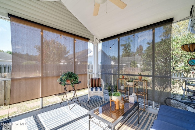 sunroom with ceiling fan and vaulted ceiling