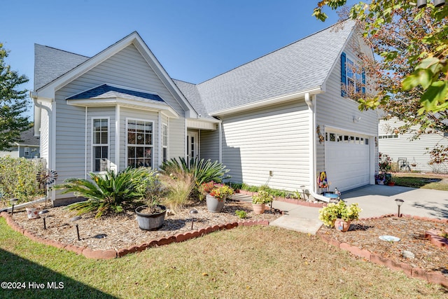 view of front of house with a front yard and a garage