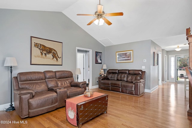 living room featuring light hardwood / wood-style floors, lofted ceiling, and ceiling fan