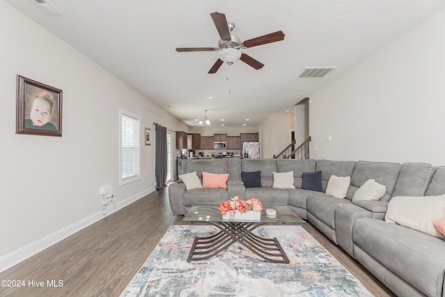 living room featuring hardwood / wood-style flooring and ceiling fan