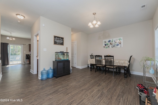 dining room featuring an inviting chandelier and dark hardwood / wood-style floors