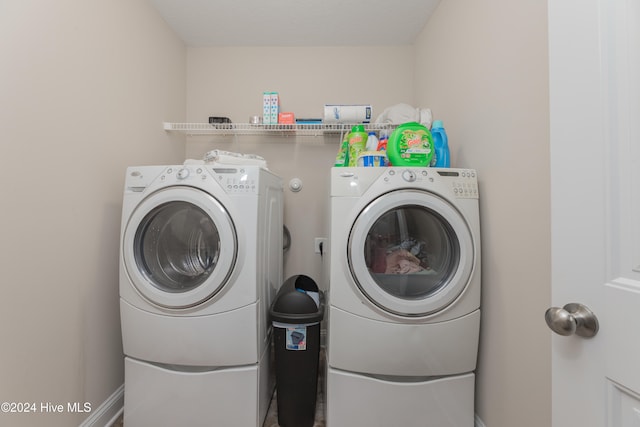 clothes washing area with separate washer and dryer