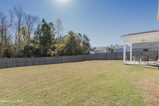 view of yard with a patio and ceiling fan