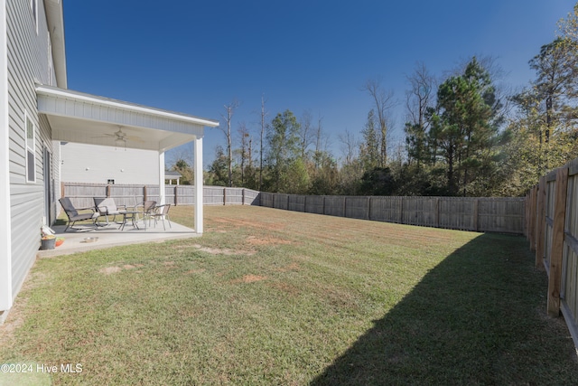 view of yard featuring ceiling fan and a patio area