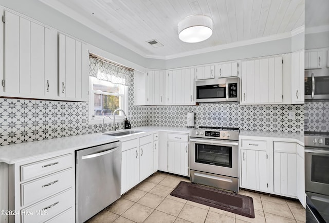 kitchen featuring sink, white cabinets, ornamental molding, and appliances with stainless steel finishes