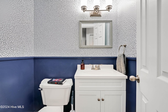 bathroom featuring vanity and toilet