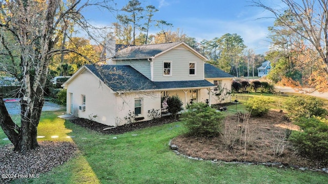 view of side of property featuring a yard