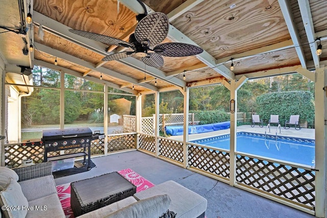 view of pool featuring ceiling fan and a grill