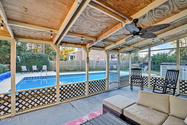 view of pool featuring ceiling fan and a patio