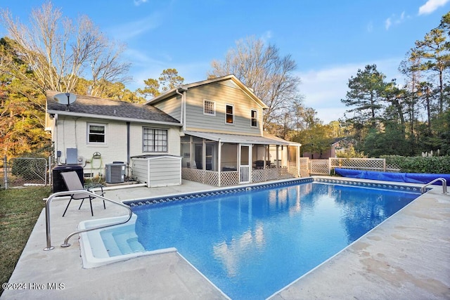 view of pool with central AC unit and a sunroom