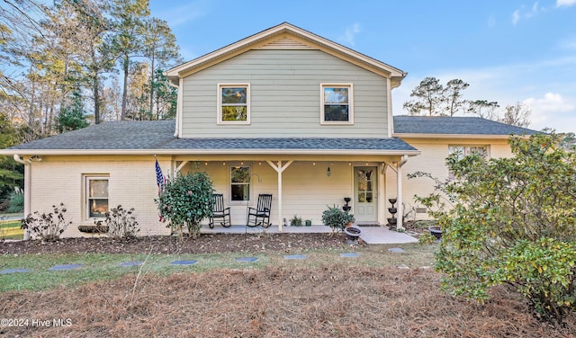 view of property featuring covered porch