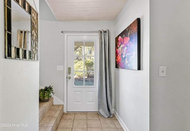 doorway with light tile patterned floors and wood ceiling