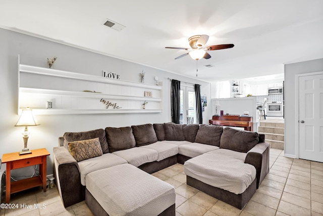 tiled living room with ceiling fan