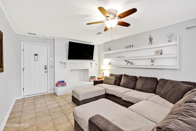 tiled living room with crown molding, a fireplace, and ceiling fan