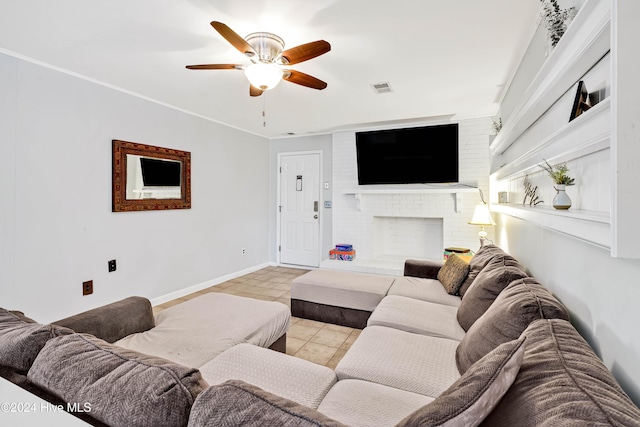 tiled living room with ceiling fan and a fireplace